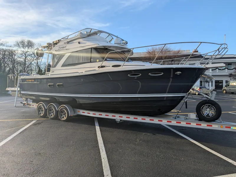 Slide: The Image of 2022 Cutwater C-32 CB boat on trailer in parking lot, side view. - 3