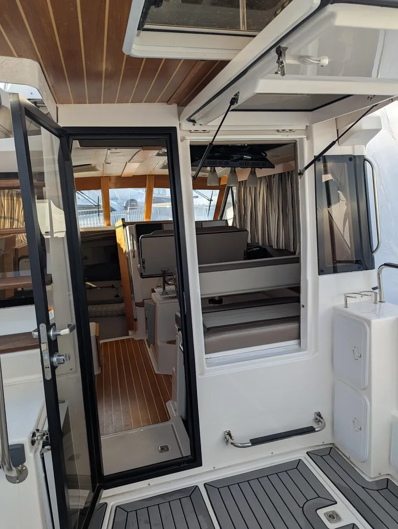 Slide: The Image of Interior view of 2022 Cutwater C-32 CB boat, featuring modern design and wood accents. - 33