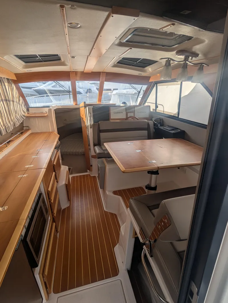 Slide: The Image of Interior of 2022 Cutwater C-32 CB boat with wood accents and seating area. - 34