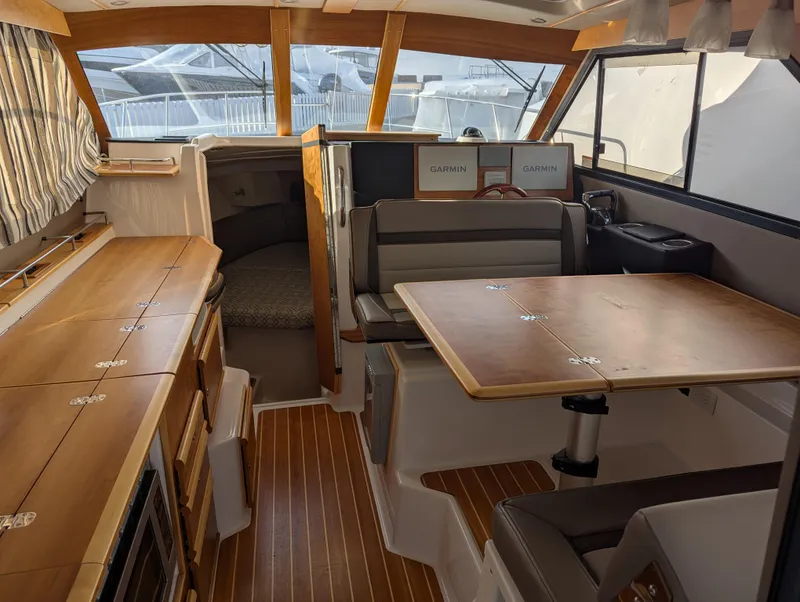 Slide: The Image of Interior of 2022 Cutwater C-32 CB yacht with wood finishes and seating area. - 35