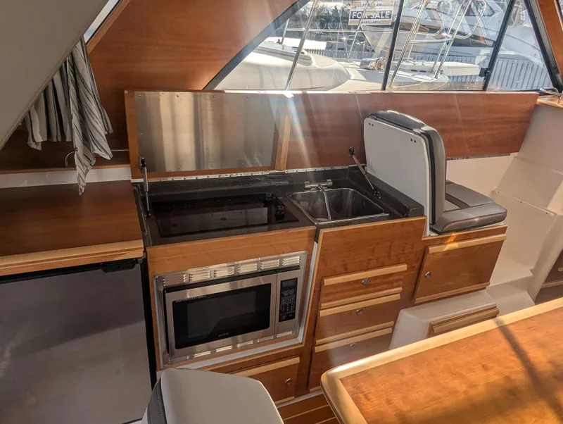 Slide: The Image of 2022 Cutwater C-32 CB yacht interior with kitchenette, featuring microwave and sink. - 40
