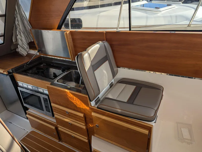 Slide: The Image of Interior of 2022 Cutwater C-32 CB boat with kitchen and seating area. - 41
