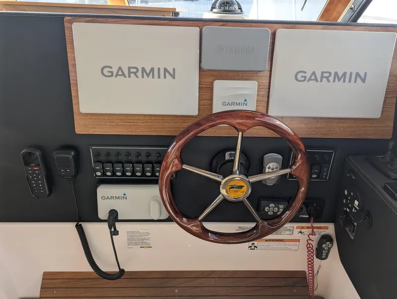 Slide: The Image of 2022 Cutwater C-32 CB helm with Garmin navigation and wooden steering wheel. - 42
