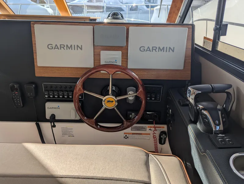Slide: The Image of 2022 Cutwater C-32 CB helm with Garmin navigation system and wooden steering wheel. - 43