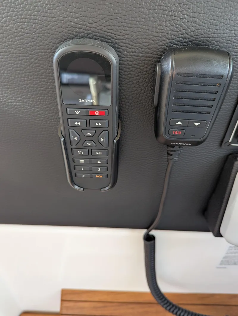 Slide: The Image of Garmin marine radio controls on 2022 Cutwater C-32 CB boat dashboard. - 47