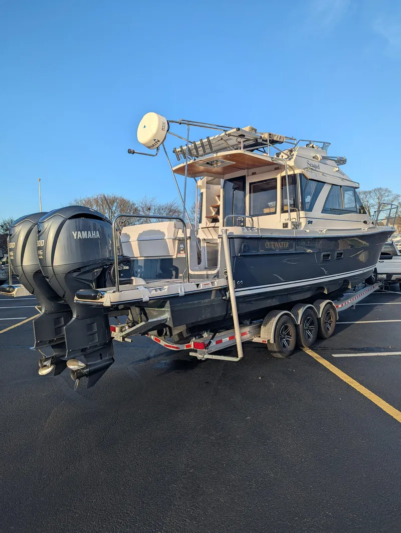 Slide: The Image of 2022 Cutwater C-32 CB boat on trailer with Yamaha engines in parking lot. - 5