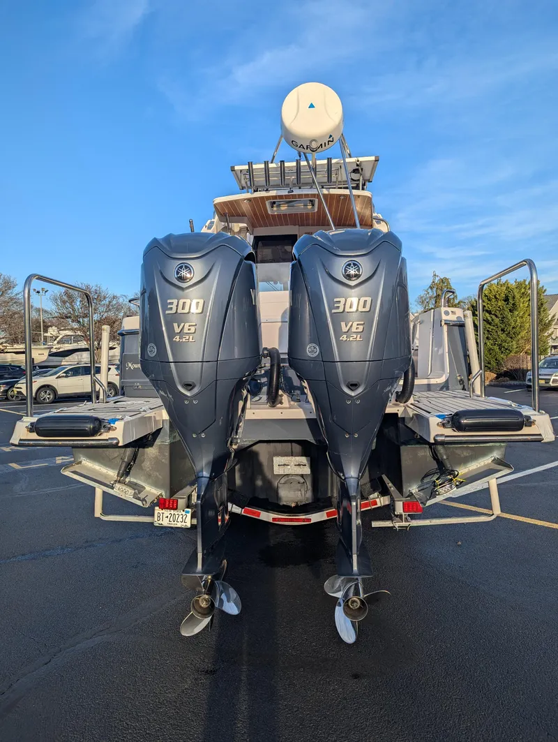 Slide: The Image of 2022 Cutwater C-32 CB boat with dual 300 V6 engines, docked in a marina. - 6
