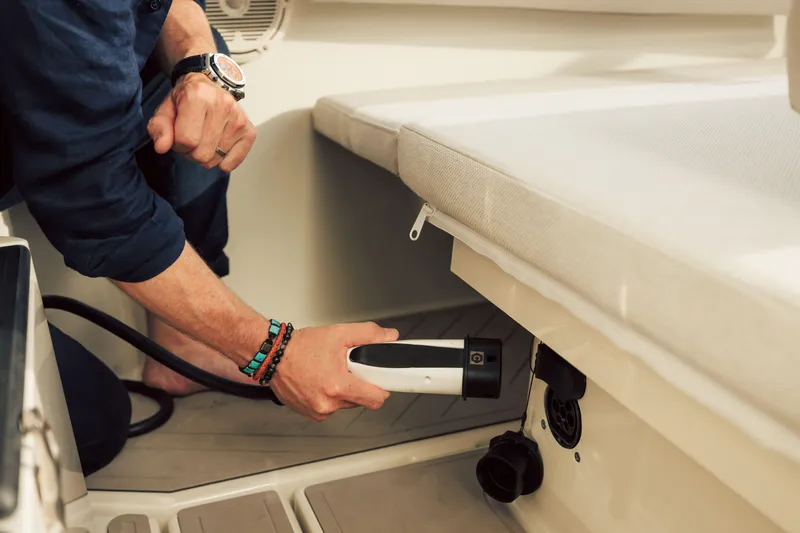 Slide: The Image of 2025 Axopar AX/E 25 electric boat with EVOY® STORM engines cruising on water. - 4