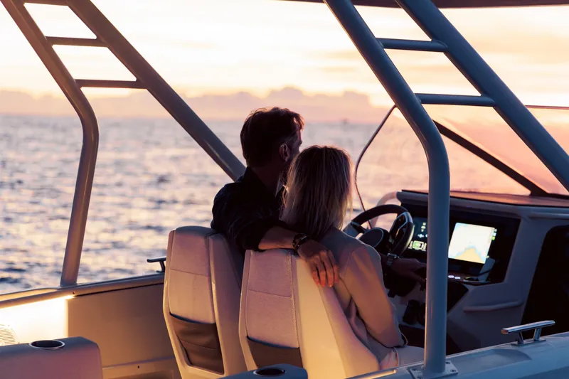 Slide: The Image of 2025 Axopar AX/E 25 electric boat with EVOY® STORM engines on open water. - 9