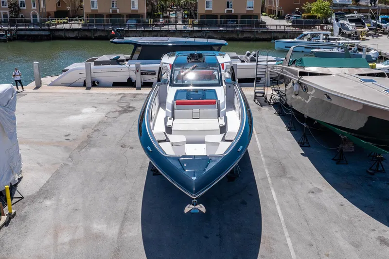 Slide: The Image of 2021 Cigarette 59 Tirranna boat docked, showcasing sleek design and luxury features. - 10