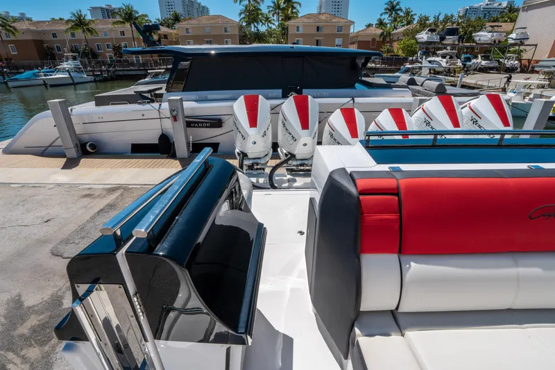 Slide: The Image of 2021 Cigarette 59 Tirranna boat with red and white seating, docked at a marina. - 12