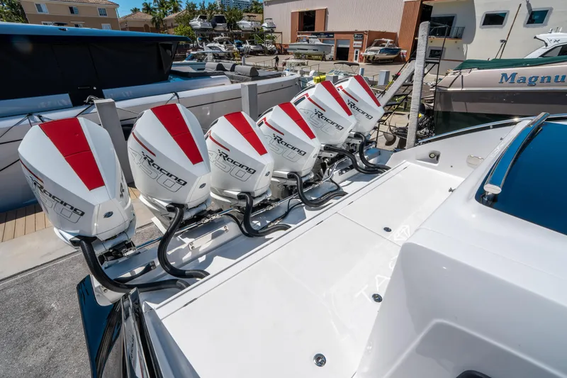 Slide: The Image of 2021 Cigarette 59 Tirranna boat with six powerful outboard engines docked at a marina. - 13