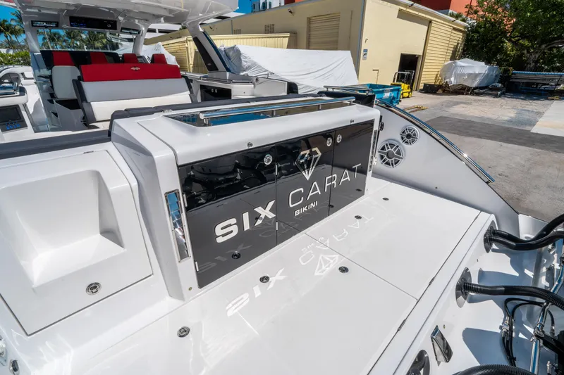 Slide: The Image of 2021 Cigarette 59 Tirranna luxury boat with "Six Carat" branding, docked outdoors. - 15