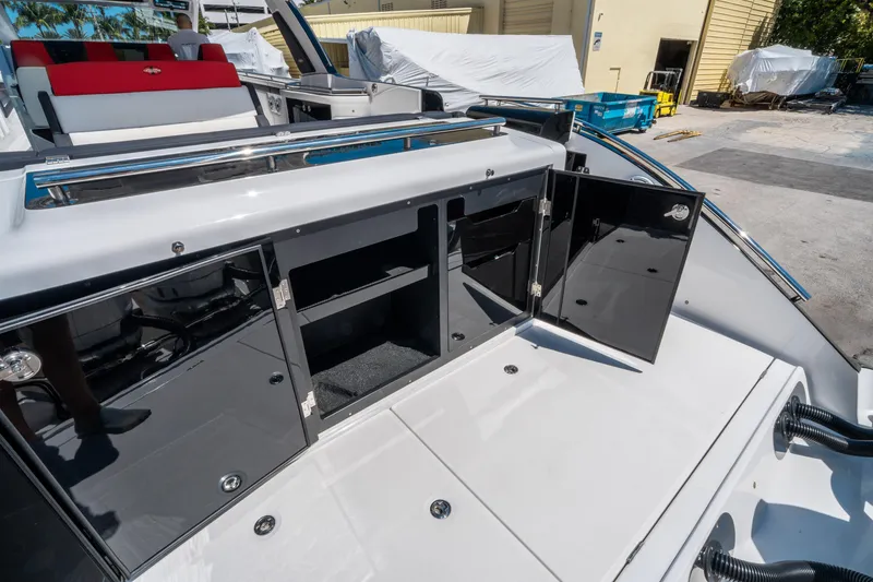 Slide: The Image of 2021 Cigarette 59 Tirranna boat with open storage compartments on deck. - 17