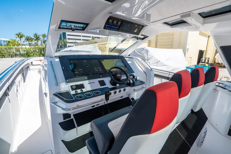 Slide: The Image of 2021 Cigarette 59 Tirranna cockpit with modern controls and red-accented seating. - 22