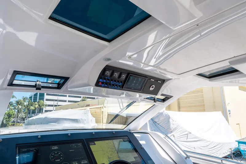 Slide: The Image of 2021 Cigarette 59 Tirranna helm with modern controls and sunroof, showcasing luxury design. - 24