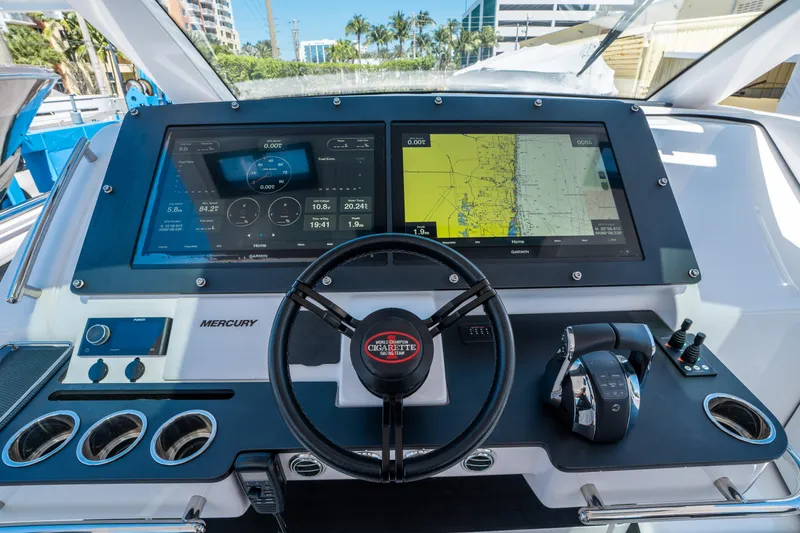 Slide: The Image of 2021 Cigarette 59 Tirranna dashboard with navigation screens and steering wheel. - 25