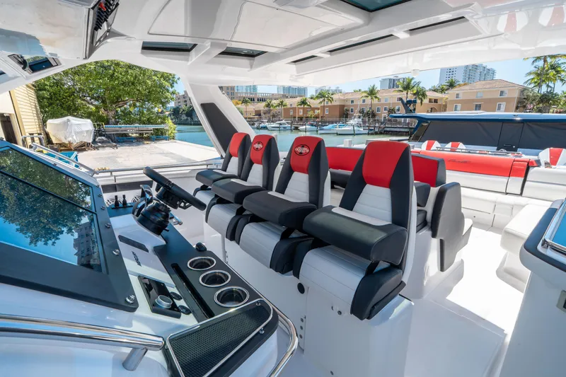 Slide: The Image of 2021 Cigarette 59 Tirranna boat interior with sleek seating and modern dashboard. - 26