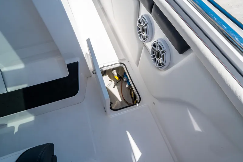 Slide: The Image of 2021 Cigarette 59 Tirranna boat interior with open storage compartment and speakers. - 31