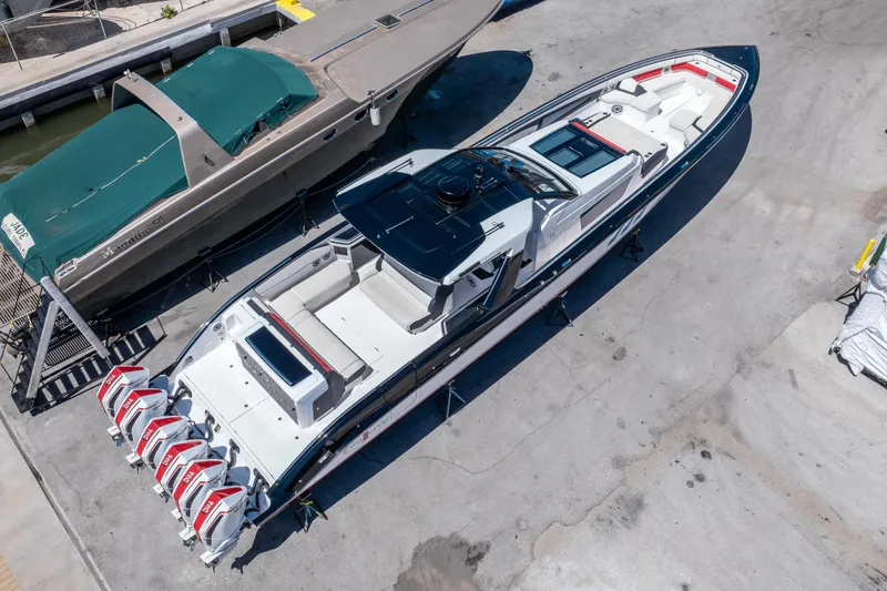 Slide: The Image of 2021 Cigarette 59 Tirranna boat with multiple engines, docked on a concrete surface. - 8