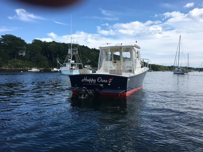 Slide: The Image of 2008 Eastern 27 boat on calm water, surrounded by other boats and lush greenery. - 3