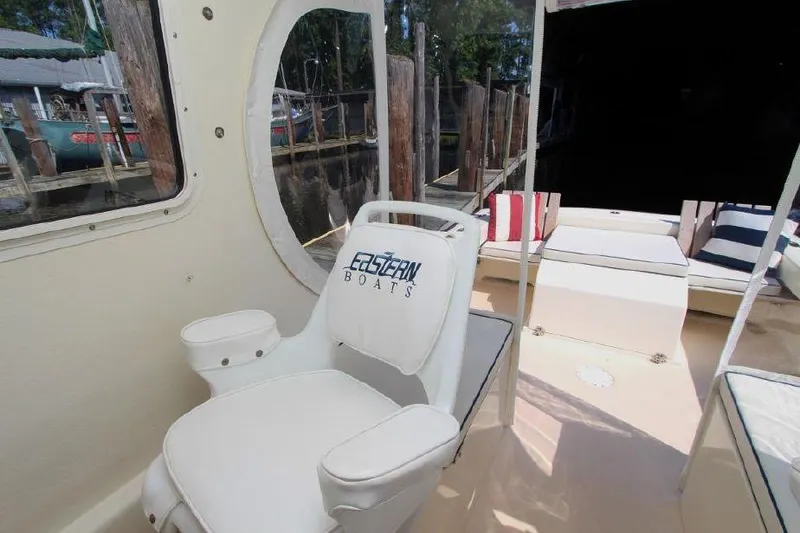 Slide: The Image of 2008 Eastern 27 boat interior with seating and window view. - 5