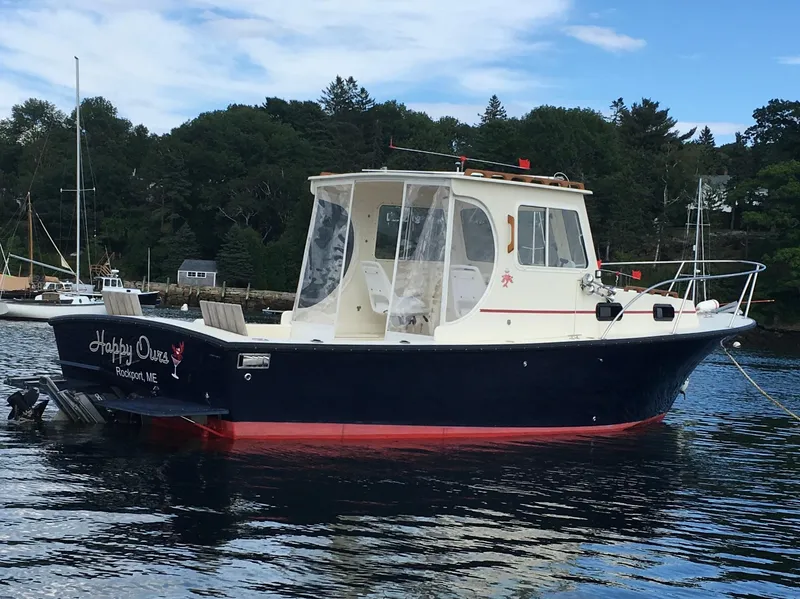 Slide: The Image of 2008 Eastern 27 boat on calm water, featuring a navy hull and white cabin. - 8