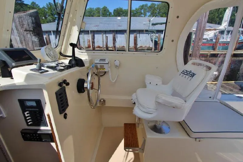 Slide: The Image of Interior of 2008 Eastern 27 boat with steering wheel and captain's chair. - 9