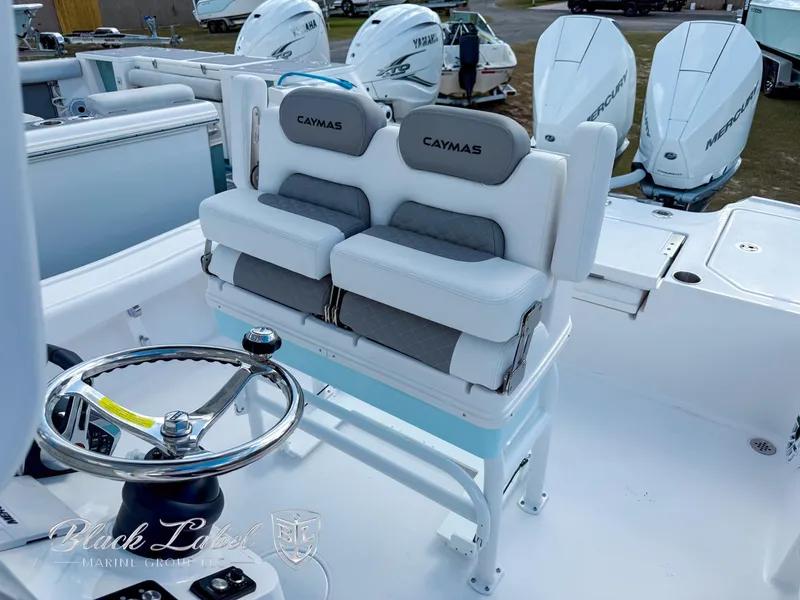 Slide: The Image of 2025 Caymas 281 HB boat interior with dual seats and steering wheel. - 15