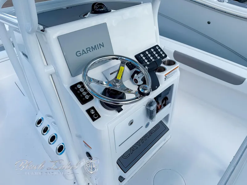 Slide: The Image of 2025 Caymas 281 HB boat console with Garmin navigation and steering wheel. - 16