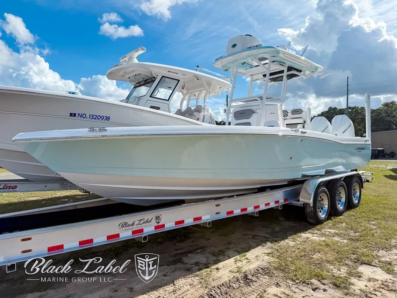 Slide: The Image of 2025 Caymas 281 HB boat on trailer, displayed by Black Label Marine Group. - 2