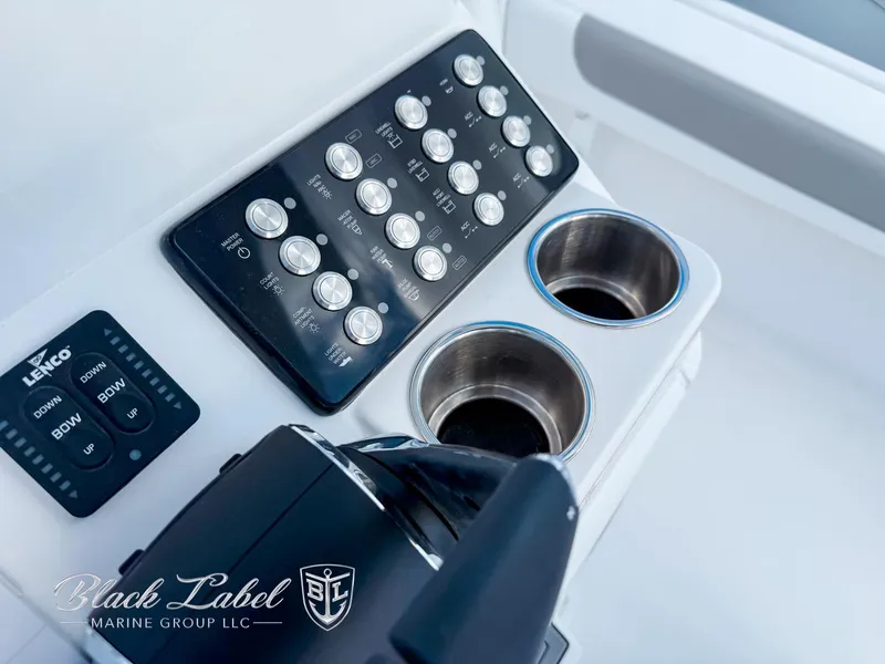 Slide: The Image of Control panel and cup holders on a 2025 Caymas 281 HB boat. - 20