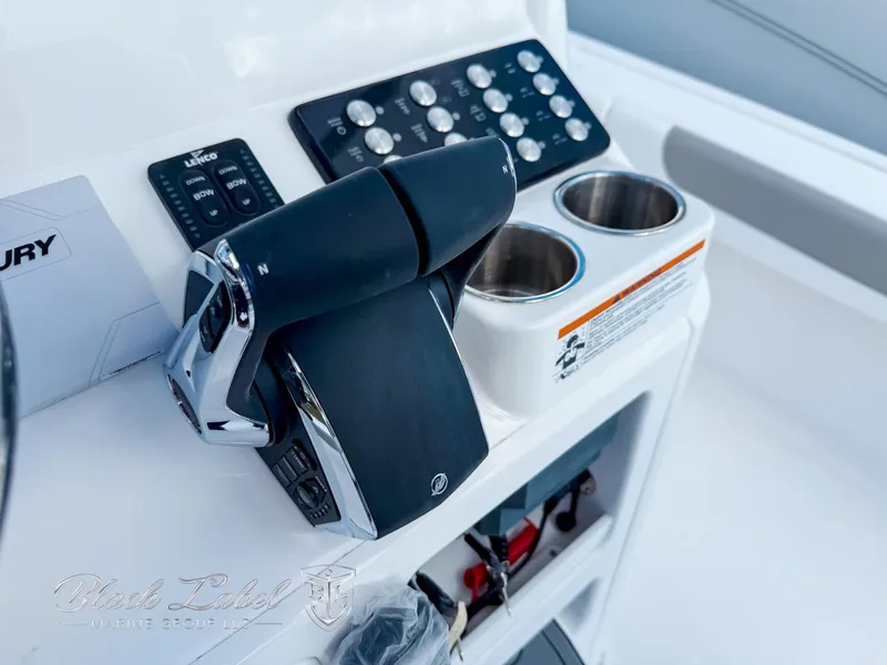 Slide: The Image of 2025 Caymas 281 HB boat console with controls and cup holders. - 21