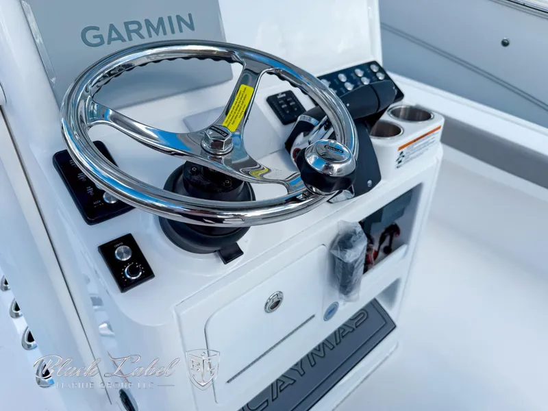 Slide: The Image of 2025 Caymas 281 HB boat helm with Garmin navigation and stainless steel steering wheel. - 22