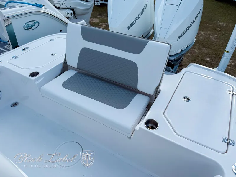 Slide: The Image of 2025 Caymas 281 HB boat seating area with storage compartments and Mercury engines. - 24