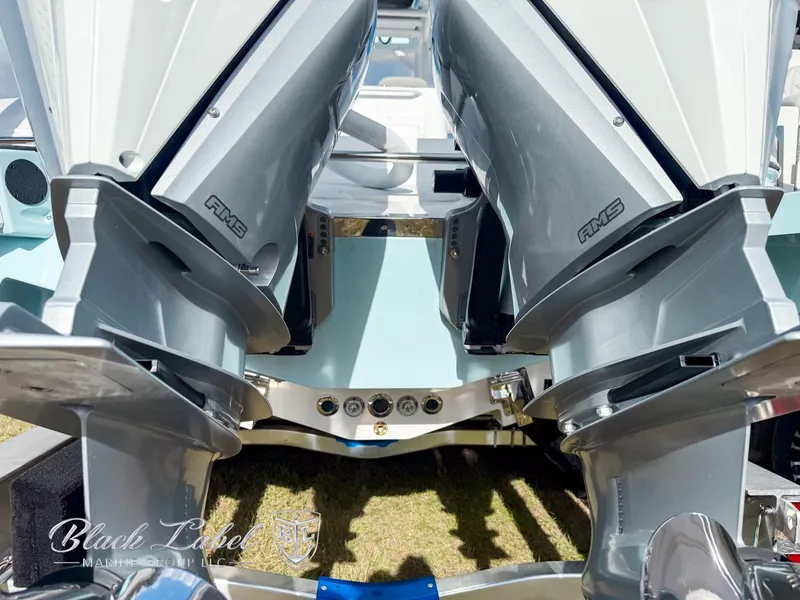 Slide: The Image of 2025 Caymas 281 HB boat engines, close-up view, showcasing powerful dual outboard motors. - 31