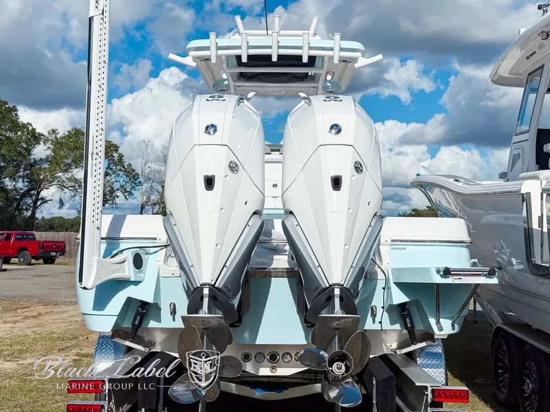 Slide: The Image of 2025 Caymas 281 HB boat with dual outboard engines, displayed outdoors. - 4