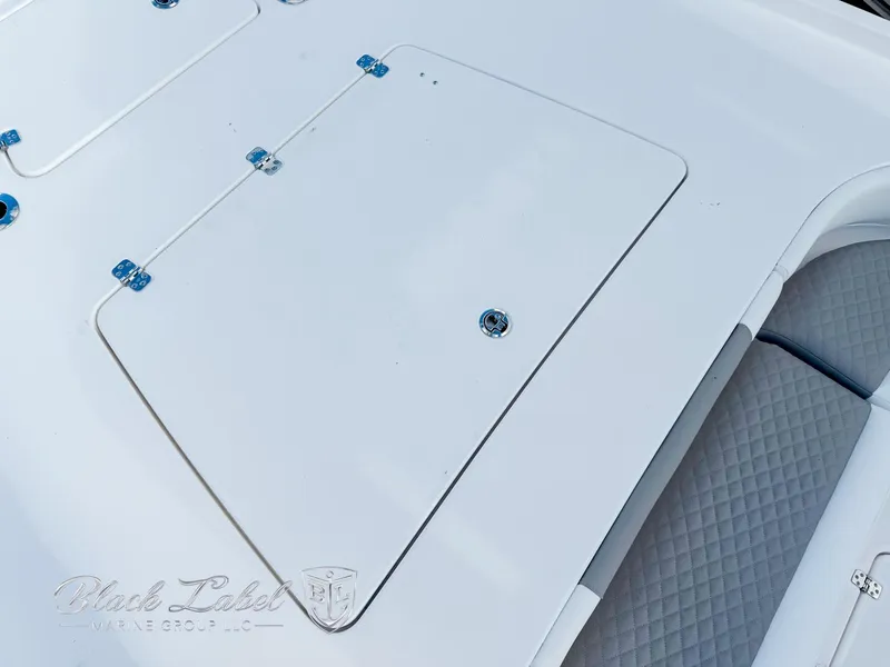 Slide: The Image of 2025 Caymas 281 HB boat deck with storage compartment and cushioned seating. - 9