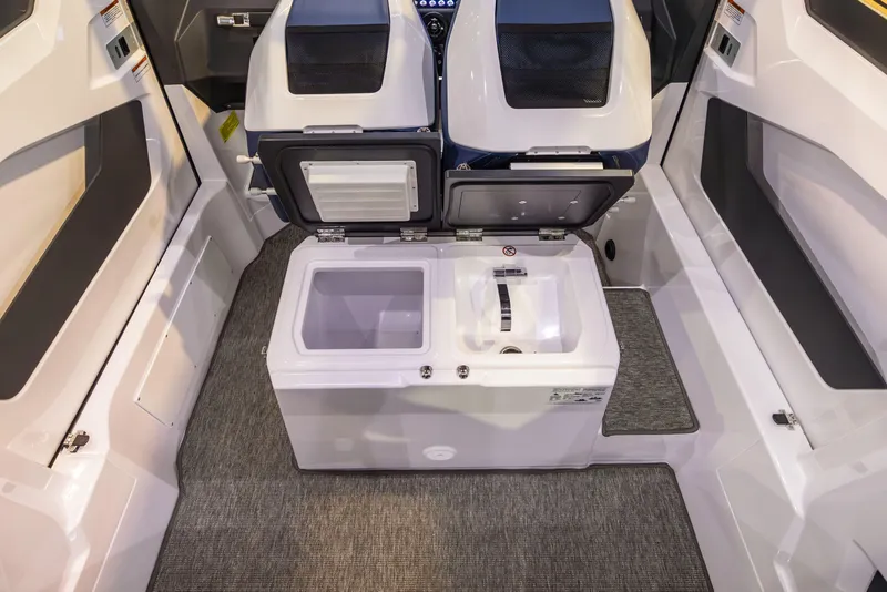 Slide: The Image of 2025 Axopar 29 XC interior with open storage compartments and carpeted flooring. - 11