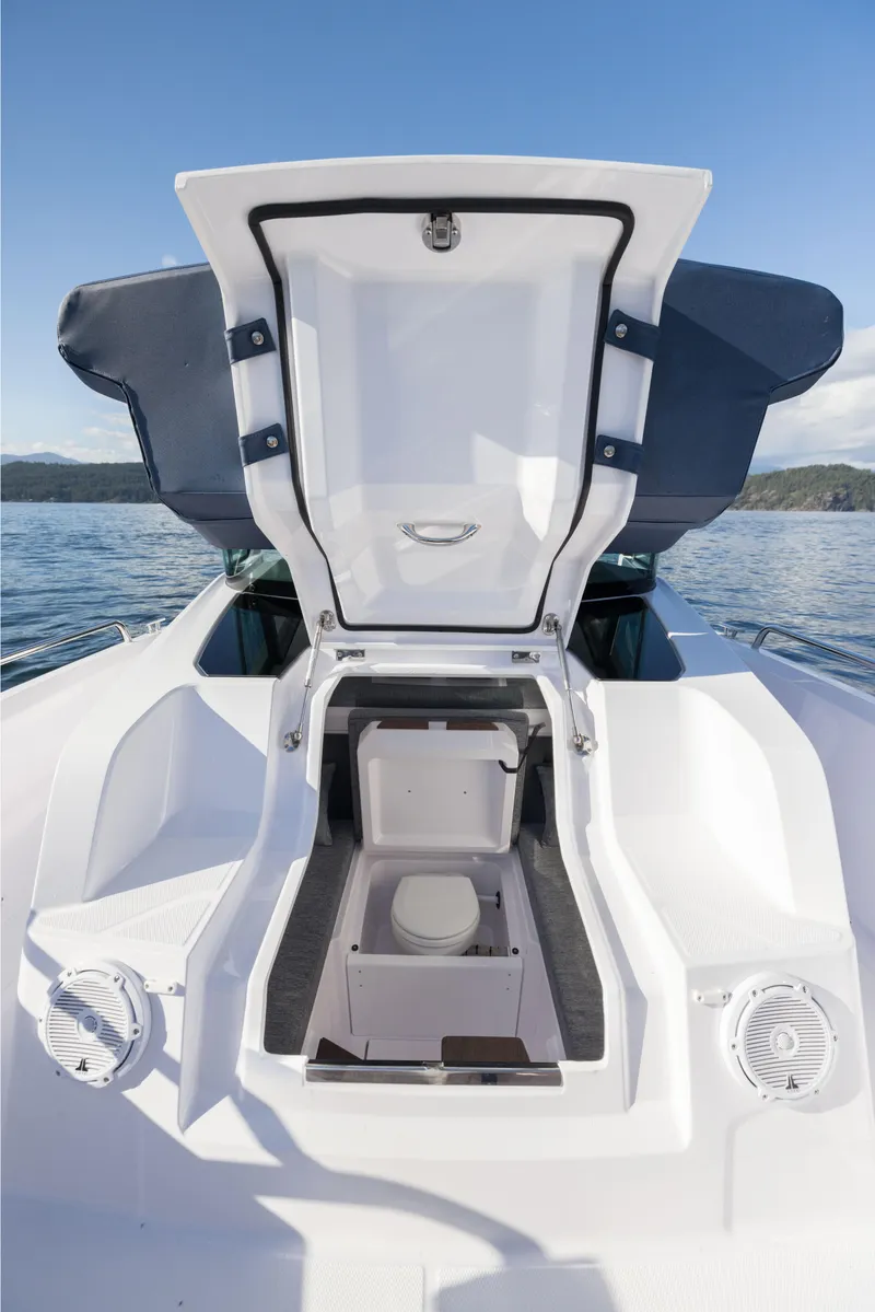 Slide: The Image of 2025 Axopar 29 XC boat with open storage compartment on deck. - 12