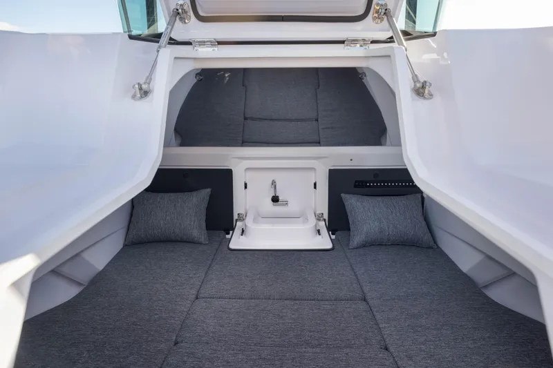 Slide: The Image of 2025 Axopar 29 XC cabin interior with gray cushions and sleek design. - 14