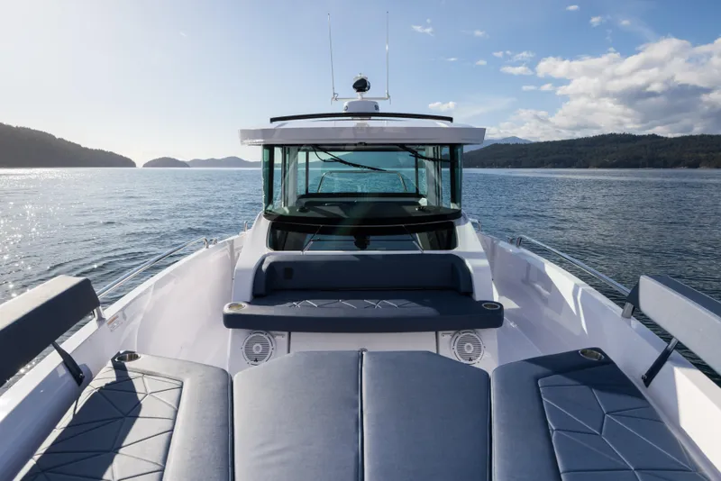 Slide: The Image of 2025 Axopar 29 XC boat on open water, showcasing sleek design and modern features. - 8