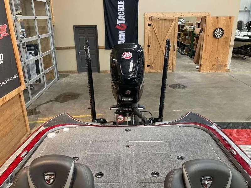 Slide: The Image of 2017 Triton 21 TrX boat interior with motor in a garage setting. - 11