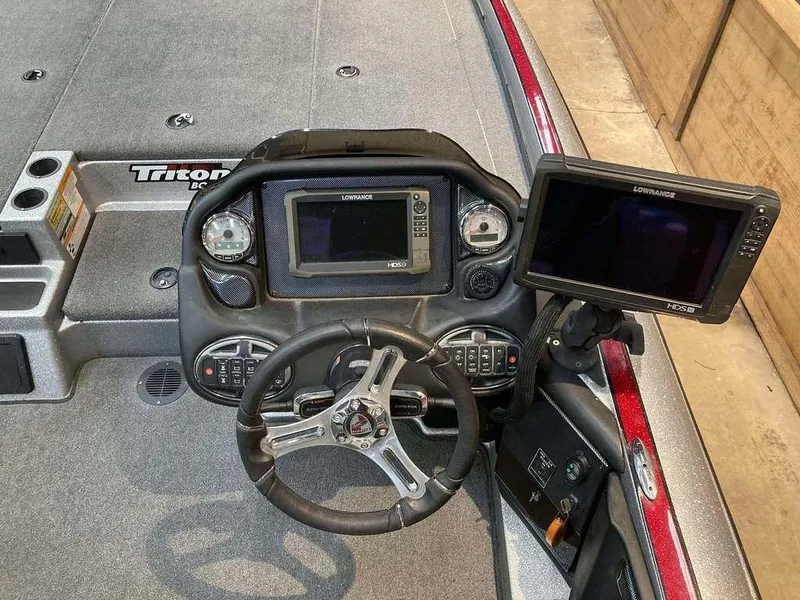 Slide: The Image of 2017 Triton 21 TrX boat dashboard with steering wheel and electronic displays. - 7