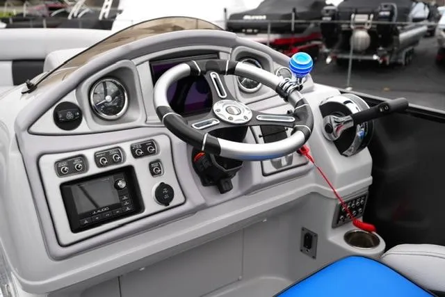 Slide: The Image of 2019 South Bay 523SB2 boat dashboard with steering wheel and controls. - 10