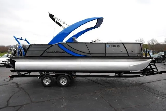 Slide: The Image of 2019 South Bay 523SB2 pontoon boat on trailer, featuring sleek design and blue accents. - 4