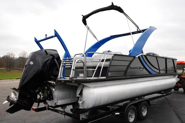 Slide: The Image of 2019 South Bay 523SB2 pontoon boat on trailer, featuring sleek design and powerful outboard motor. - 5