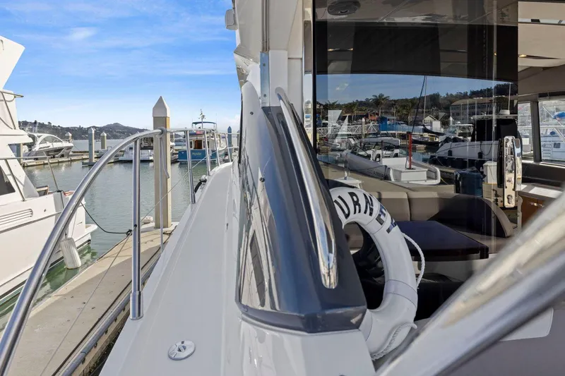 Slide: The Image of 2019 Princess V50 yacht docked at marina, showcasing sleek design and luxurious interior. - 11