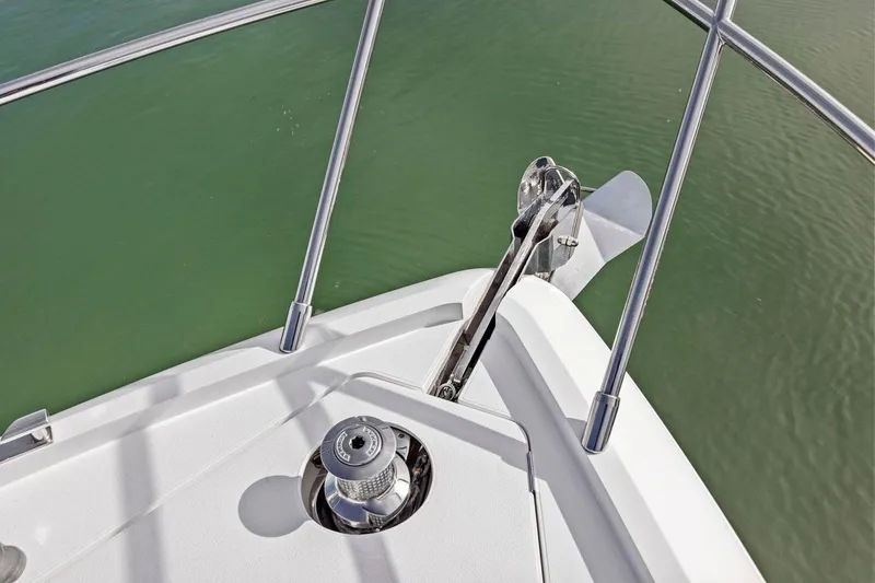 Slide: The Image of Bow of 2019 Princess V50 yacht with anchor and railing over water. - 15