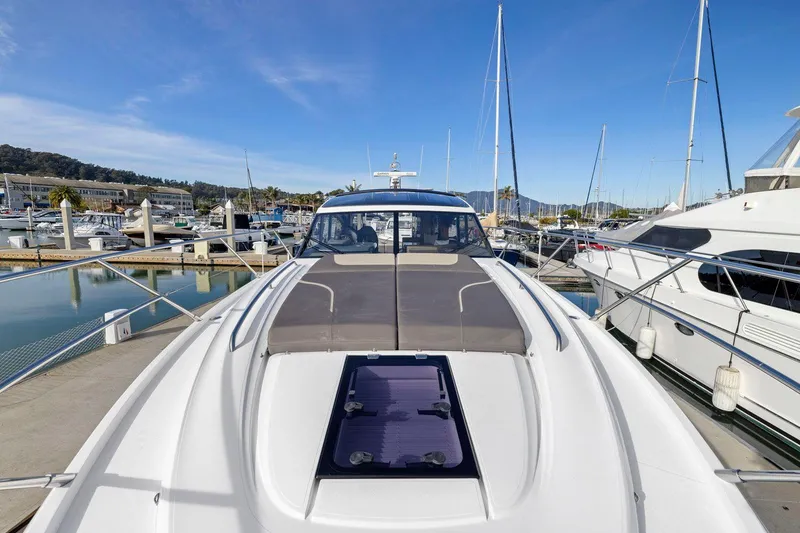 Slide: The Image of 2019 Princess V50 yacht docked at marina under clear blue sky. - 16